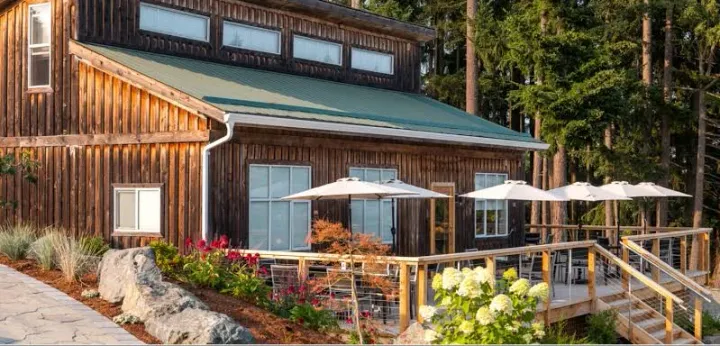 Rustic wooden building with a patio deck and umbrellas, Cobble Hill BC