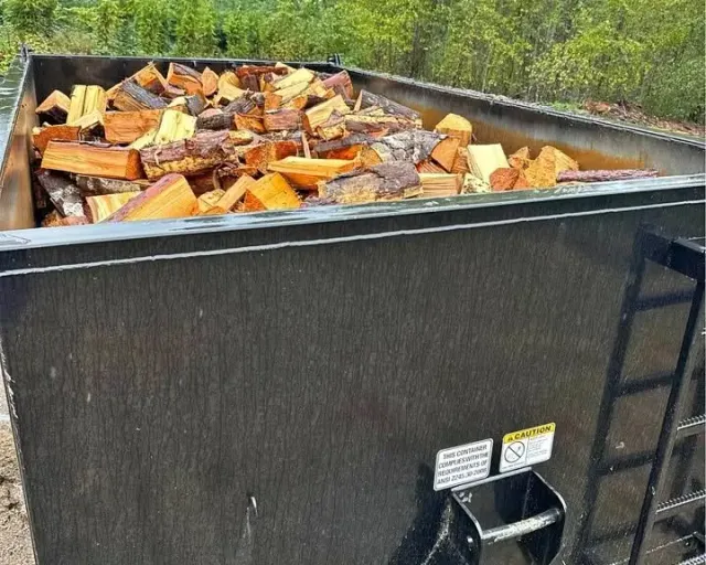 Firewood in Cobble Hill BC: a large metal bin filled with split firewood
