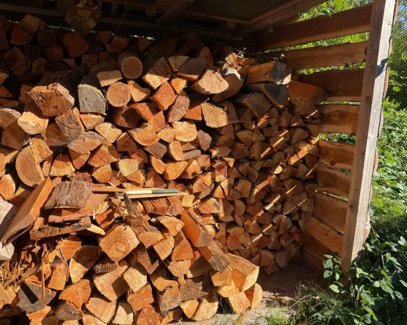 Firewood in Duncan BC: split wood stacked in a sunny open woodshed