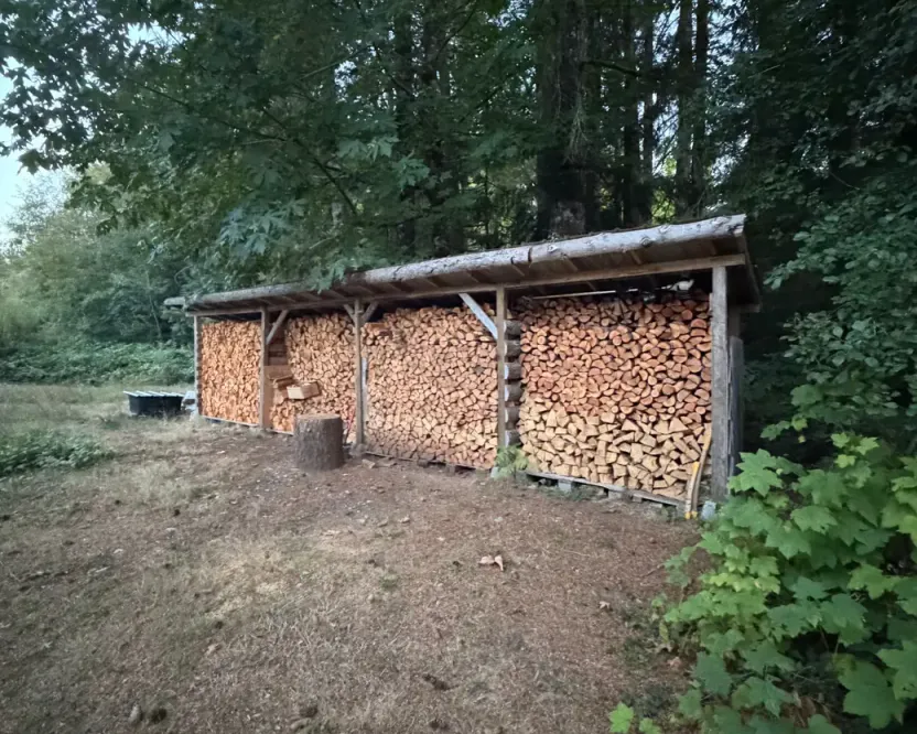 Firewood in Langford BC: a long woodshed full of stacked split wood