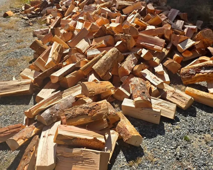 Firewood delivery in Nanaimo BC: a load of split firewood dumped on a gravel driveway