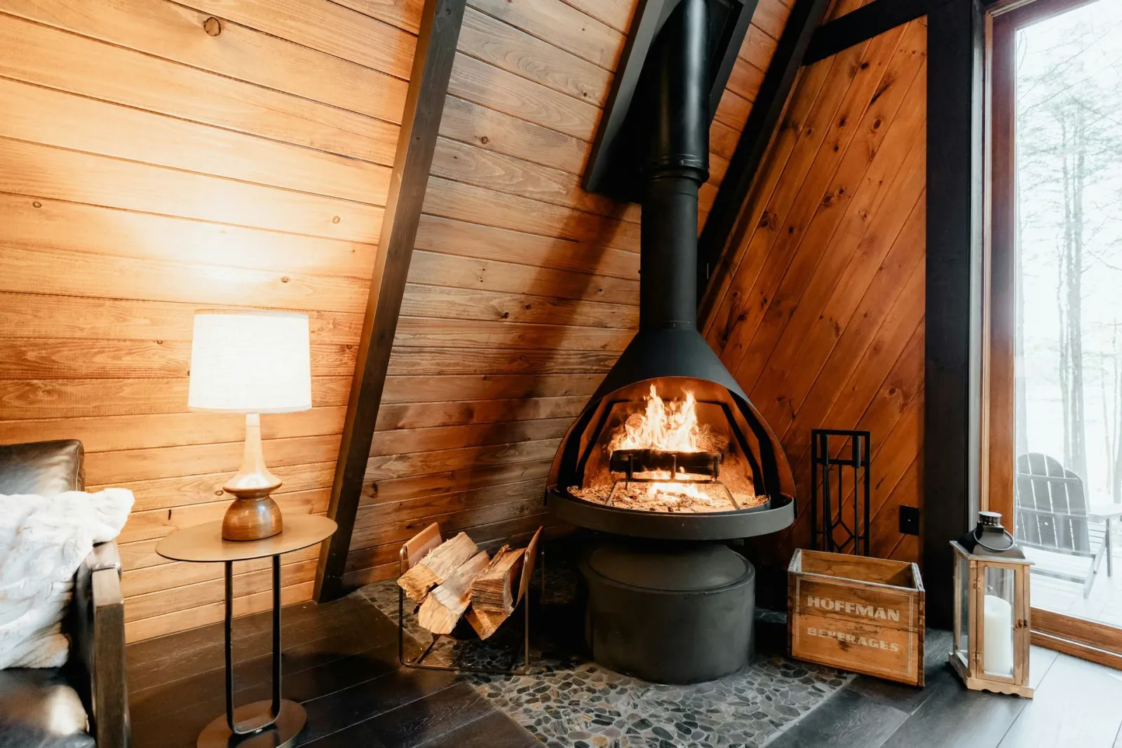 Wood stove burning in a cozy A-frame cabin, Cowichan Valley BC