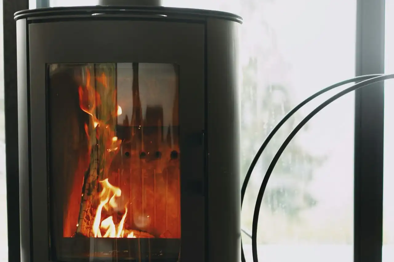 Modern wood stove burning beside a window, Victoria BC